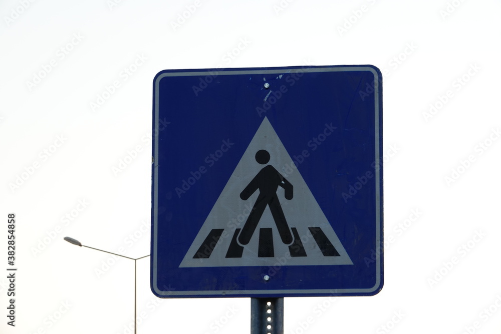 Pedestrian crossing sign black white on blue Pedestrian crossing sign black white on blue