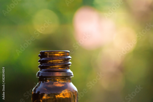 Essential aromatherapy concept, closeup of dark glass bottle