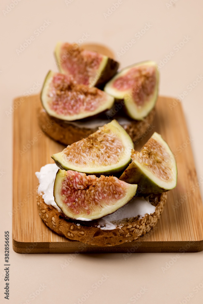 Tasty Canape or Crostini Toasted Baguette Cream Cheese and Figs on Wooden Board Delicious Appetizer Lunch Yellow Background Vertical Tasty Canape or Crostini Toasted Baguette Cream Cheese and Figs on Wooden Board Delicious Appetizer Lunch Yellow Background Vertical