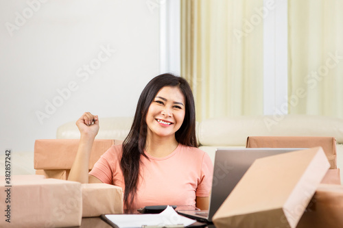 Young woman online shop owner smiling at the camera