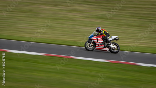 A panning shot of a racing bike cornering as it circuits a track. © SnapstitchPhoto