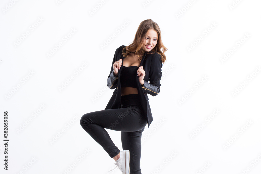 Young beautiful woman on gray wall.