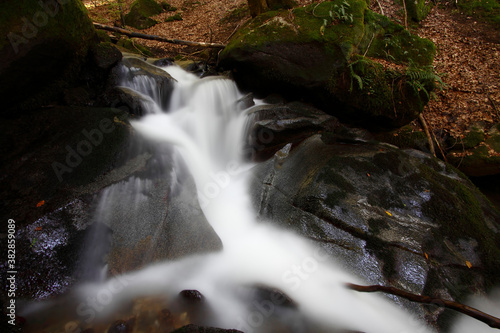 Mountain stream in autumn. Stream in the forest.