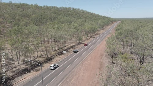 Drone shot of Cars driving down highway in Northern Territory, Australian Outback photo