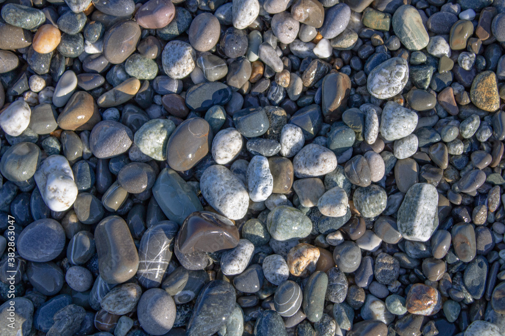 Beautiful pebbles on the Black Sea coast in Sochi in the morning sun. Beautiful pebbles on the Black Sea coast in Sochi in the morning sun.