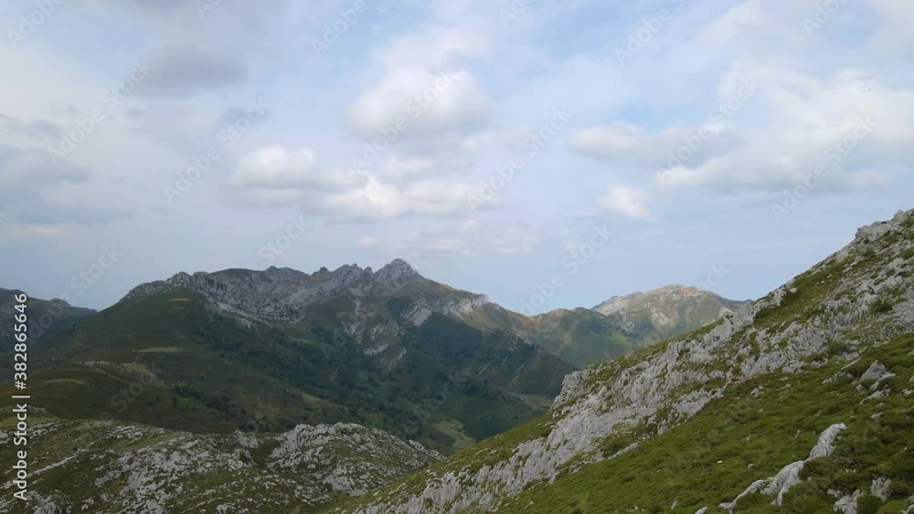 Green and rocky alpine mountain slopes, Redes Natural Park, drone push-in shot Green and rocky alpine mountain slopes, Redes Natural Park, drone push-in shot