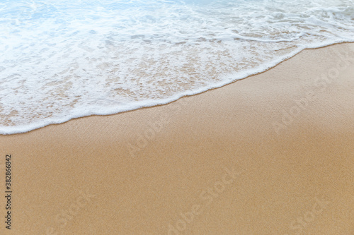 White wave on the clean sand beach, nature background, summer outdoor day light