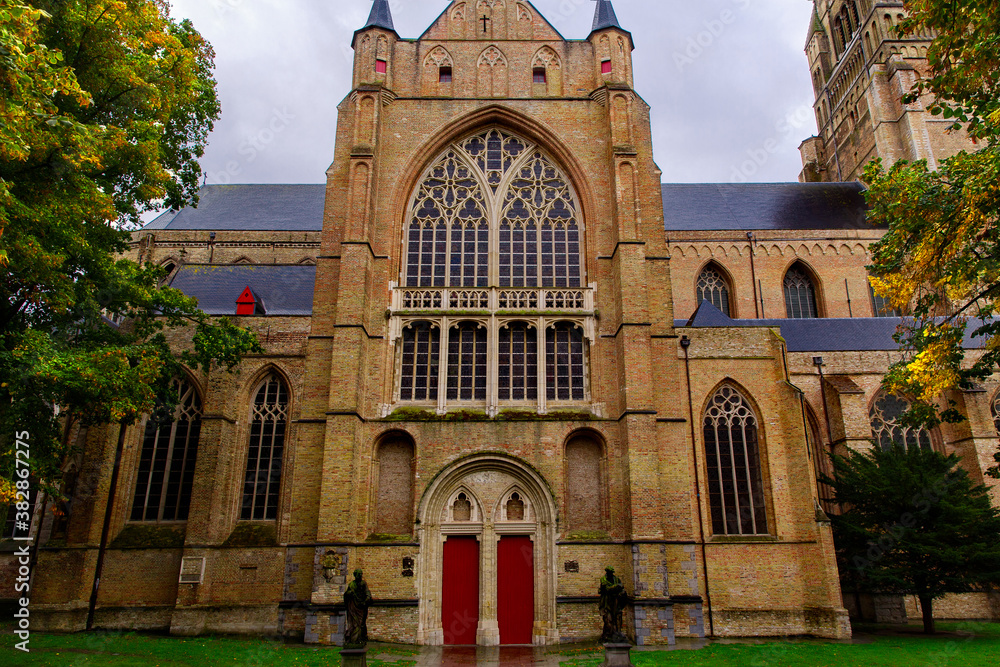 Bruges, Flanders, Belgium, Europe - October 1, 2019. Saint Salvator Cathedral made of old bricks on ancient medieval street in Bruges (Brugge). 