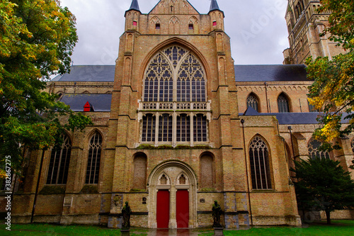 Bruges, Flanders, Belgium, Europe - October 1, 2019. Saint Salvator Cathedral made of old bricks on ancient medieval street in Bruges (Brugge). 
