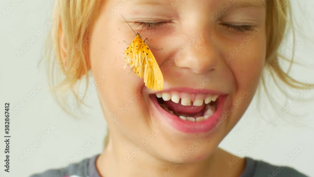 Little girl with a butterfly on her cheek Little girl with a butterfly on her cheek