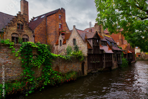 Bruges, Flanders, Belgium, Europe - October 1, 2019. Medieval ancient houses made of old bricks and water canals in Bruges (Brugge) West Flanders province, Belgium.