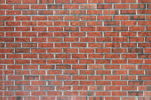 old wall made of rectangular red bricks sealed with cement