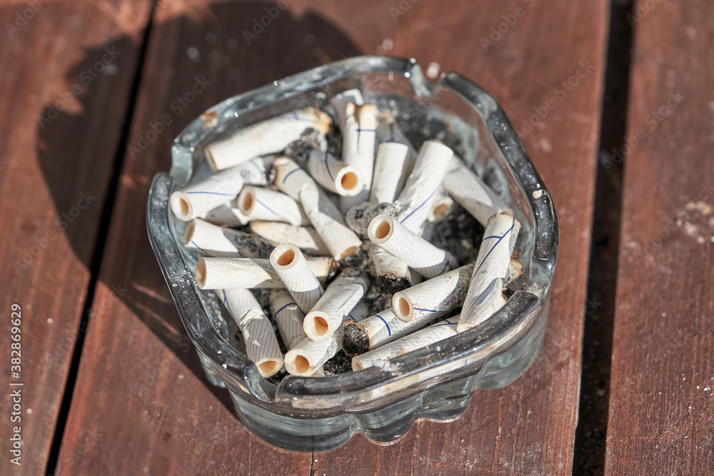 Many cigarette butts are in the ashtray Many cigarette butts are in the ashtray