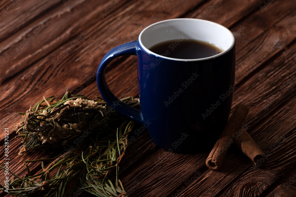 Homemade pastries and a cup of tea on an old wooden surface. Homemade strudel. Anise and fragrant herbs on the table. Low key photo. Homemade pastries and a cup of tea on an old wooden surface. Homemade strudel. Anise and fragrant herbs on the table. Low key photo.