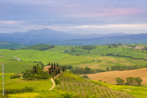 Spring sunrise over the green fields of Val d'Orcia in Tuscany