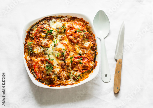 Cuadro en lienzo Eggplant, chicken, tomatoes, mozzarella cheese, tomato sauce casserole on a ligh