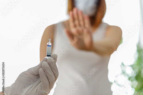 Woman wearing mask is against vaccination