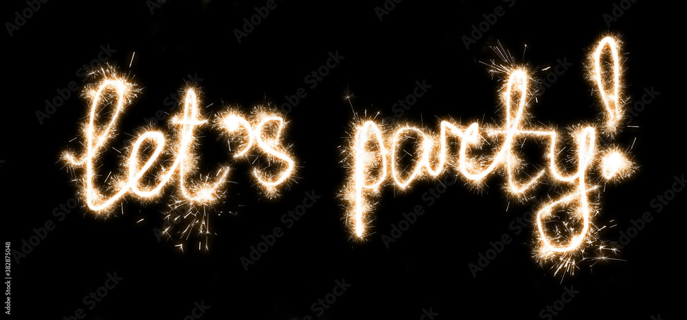The inscription with sparklers on a black background lets party. The inscription with sparklers on a black background lets party.