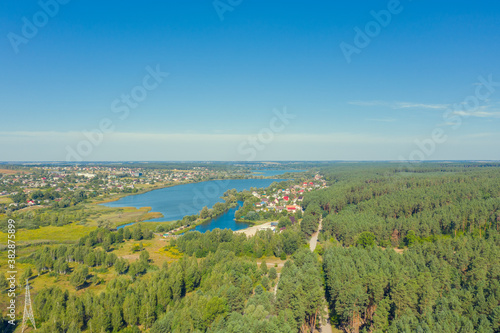 Spring rural landscape in summer   Aerial view. Panoramic view of the village and lake on a sunny day