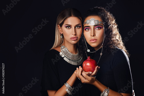 Two young women hold a red garnet in their hands as a symbol of Armenia and truce. Azerbaijani-Armenian conflict. Karabakh. Tavush conflict photo