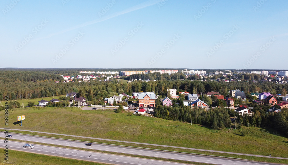 Top view of the highway near the suburb on a sunny day