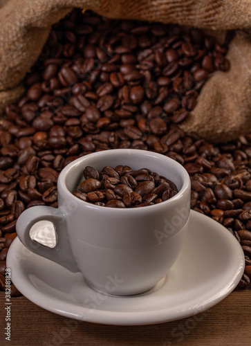 Coffee cup with coffee bag on wooden table