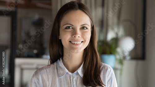 Head shot close up portrait of young european ambitions female employee. Profile photo of millennial beautiful businesswoman team leader, manager or company representative looking at camera.
