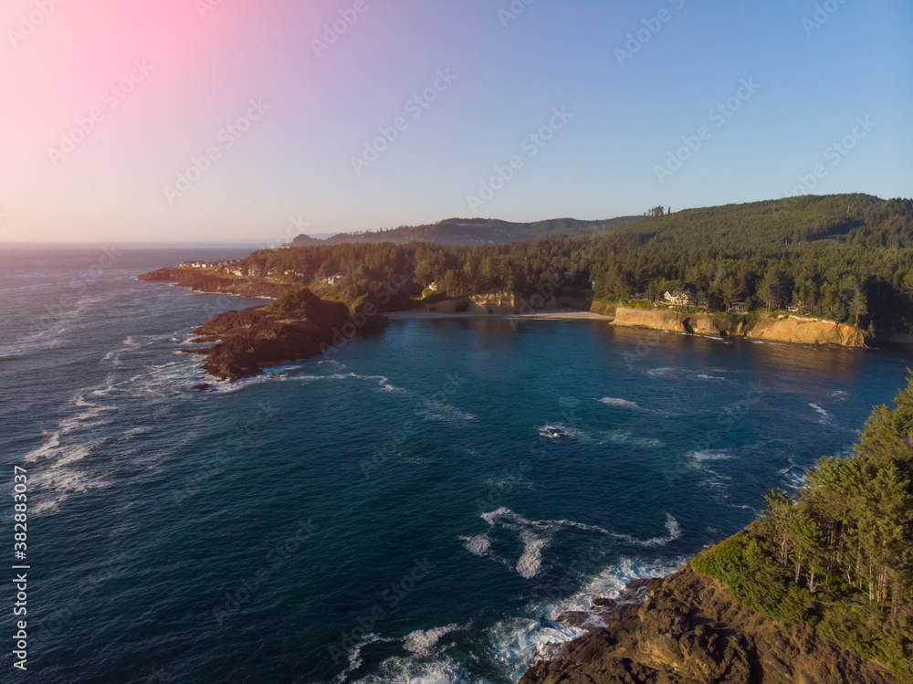 Fantastic aerial view of ocean waves and amazing rocky coast. Wonderful blue water. Warm sunny weather. Panoramic drone top view. Natural landscape.