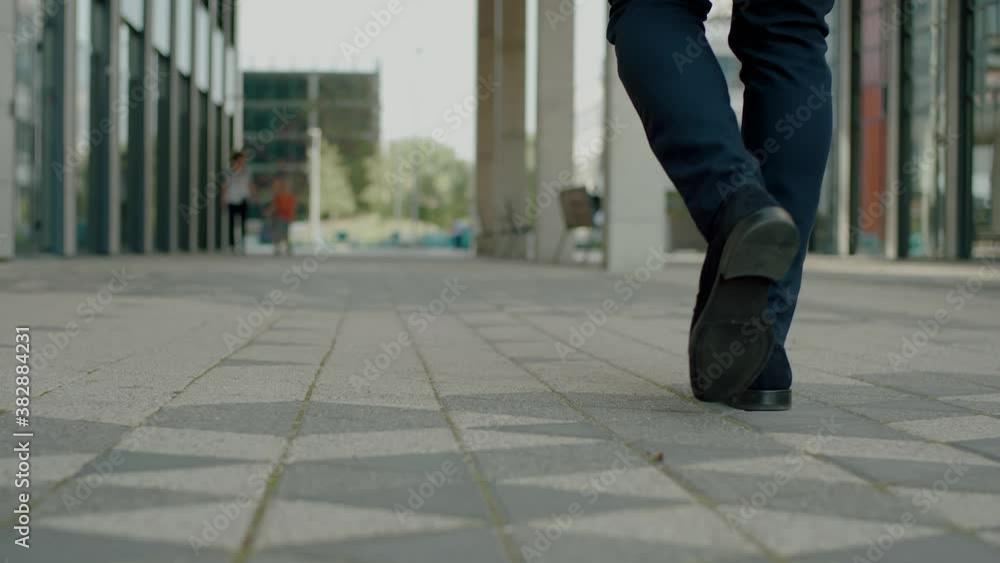 Back View of Businessman Feet Walking on Street . Back View of Businessman Feet Walking on Street .