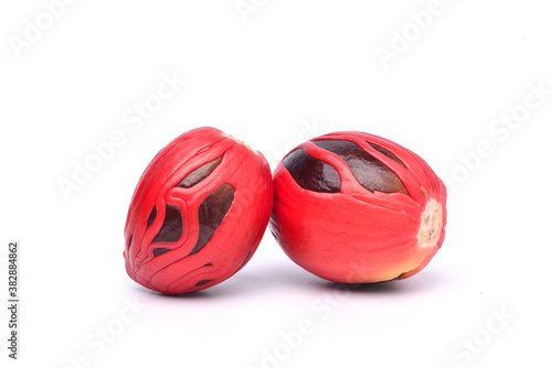 Fotografie Close-up fresh nutmeg seeds with mace isolated on white background