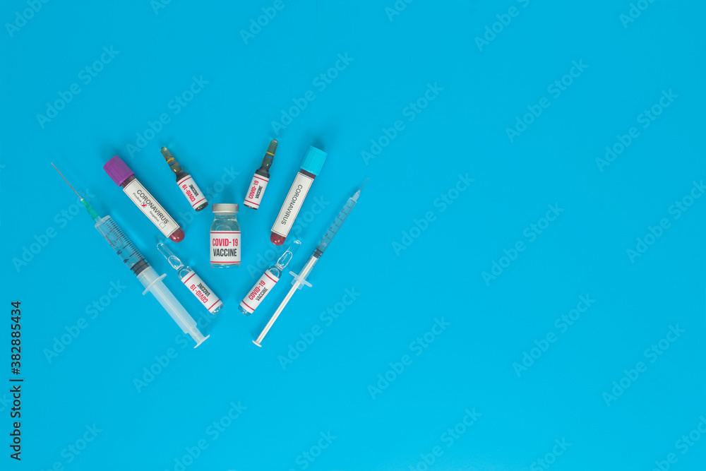 The drug for the coronavirus (covid 19) pandemic virus on a blue background. Sample vaccines and drugs used in the treatment of coronavirus. The drug for the coronavirus (covid 19) pandemic virus on a blue background. Sample vaccines and drugs used in the treatment of coronavirus.