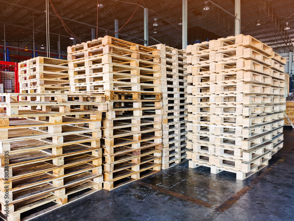 Worker driving forklift to loading wooden pallets from truck to warehouse cargo storage, shipment in logistics and transportation industrial, wood pallets stack, delivery service Worker driving forklift to loading wooden pallets from truck to warehouse cargo storage, shipment in logistics and transportation industrial, wood pallets stack, delivery service