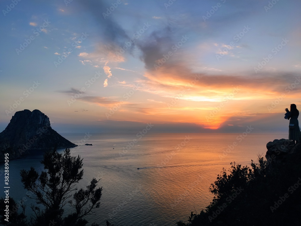 Tourist takes a photo with an amazing sunset in the mountains in Ibiza,Spain