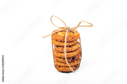 cookies with cranberries laid out in a tower and tied with twine, cord, twine. On white background. Close-up.