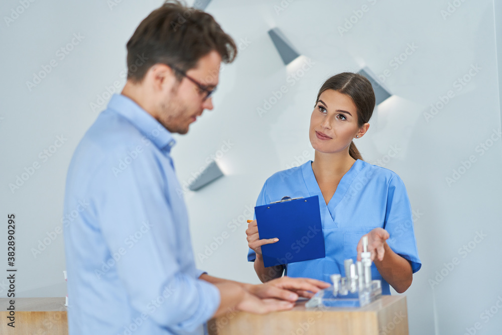 Patient signing documents in dental clinic Patient signing documents in dental clinic