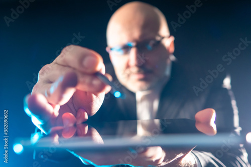 The man controls the tablet...