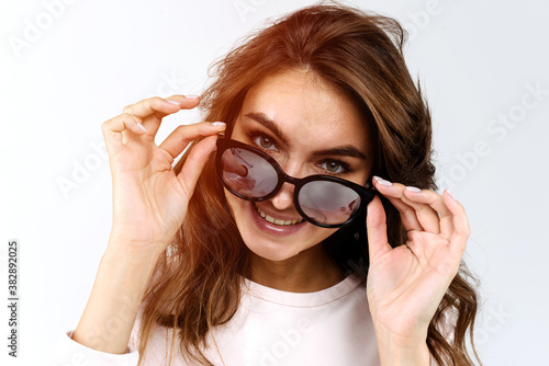 Beautiful and fashion girl in sunglasses  close-up portrait  studio shot on white background