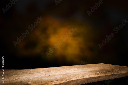 background reflection from a window on the wall, and a worn old wooden table