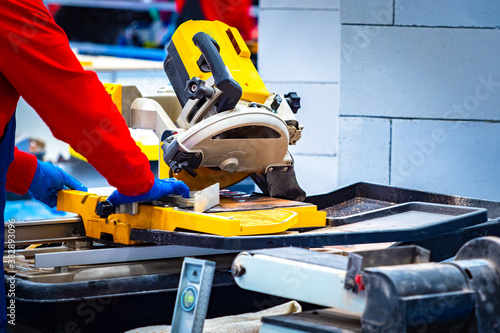 Worker saws tile on the mac...