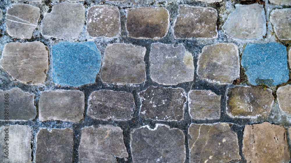 Close-up of the paved square stone ground
Close-up of the paved square stone ground