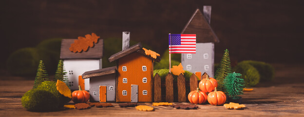 Miniature Thanksgiving little autumn cottages village in the forest, banner