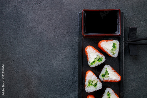 Sushi background. Salmon maki rolls on plate