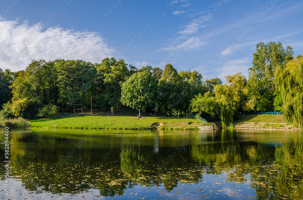 City park in the warm and sunny day during the autumn season. Landscape fulfilled of sunlight City park in the warm and sunny day during the autumn season. Landscape fulfilled of sunlight
