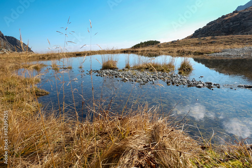Pond in Valley of Five Spis Lakes surrounded by rocky summits  High Tatra Mountains. Slovakia