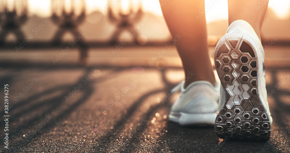 Runner woman feet running on road closeup on shoe. Female fitness model  sunrise jog workout. Sports healthy lifestyle concept. Photos | Adobe Stock