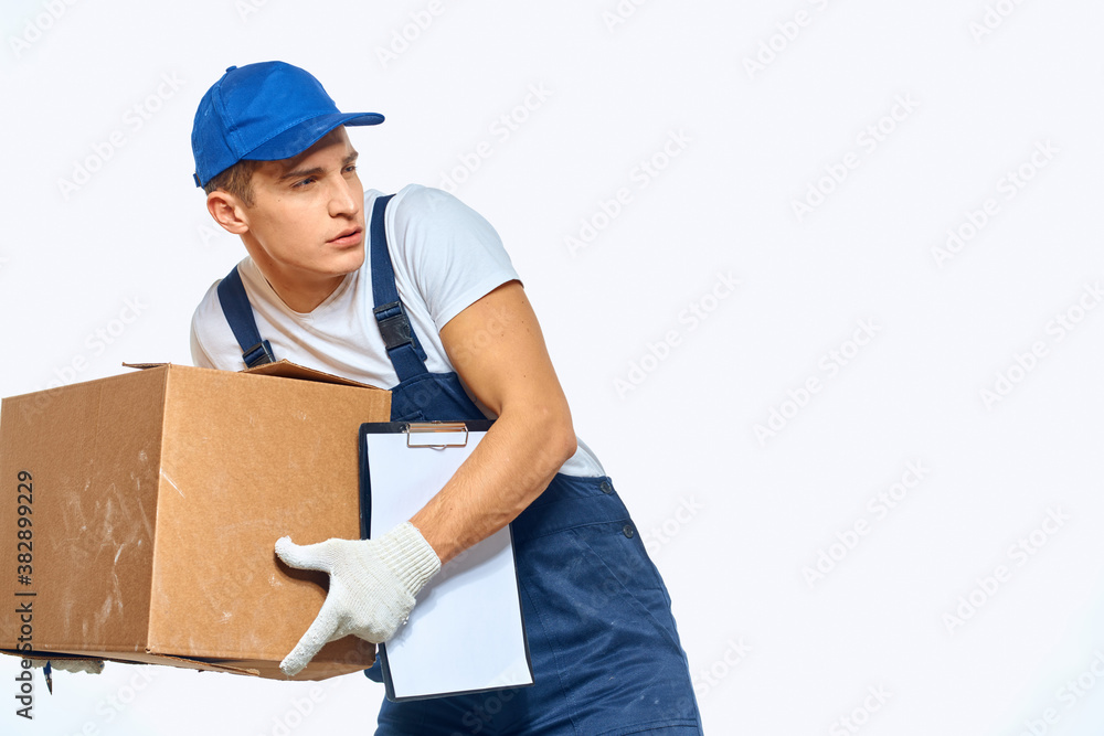 Man worker with box in hands delivery loading service work light background Man worker with box in hands delivery loading service work light background