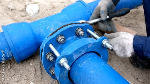 Wallpaper Mural Workers installing water supply pipeline system, close up Torontodigital.ca