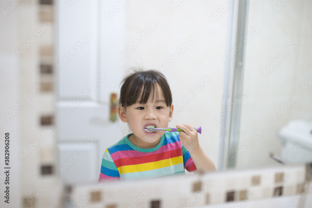young girl brushing teeth by herself in bathroom young girl brushing teeth by herself in bathroom