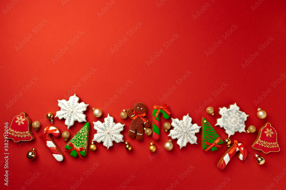 Gingerbread cookies for Christmas celebration on red background