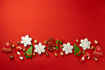 Gingerbread cookies for Christmas celebration on red background